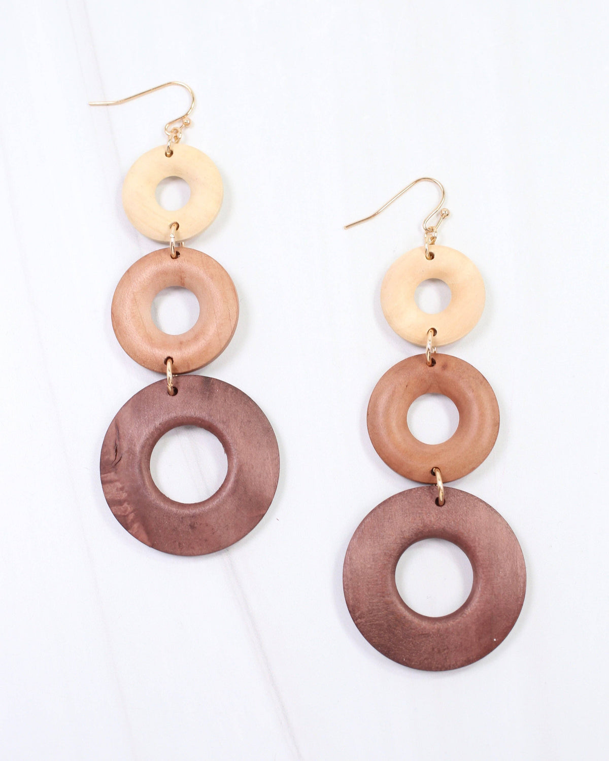 Three-tier graduated wooden ring dangle earrings in natural, tan, and brown tones