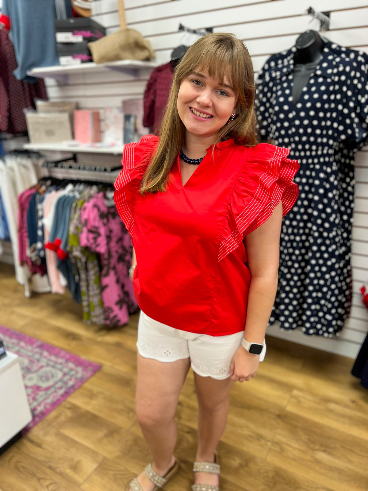 She + Sky red V-neck top with double ruffle short sleeves on model