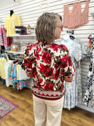 Burgundy floral print puff sleeve top with geometric hem border, back view