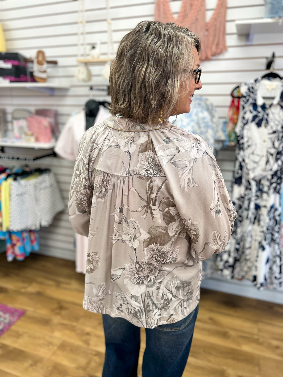 Taupe floral print blouse with 3/4 puff sleeves and gathered back yoke