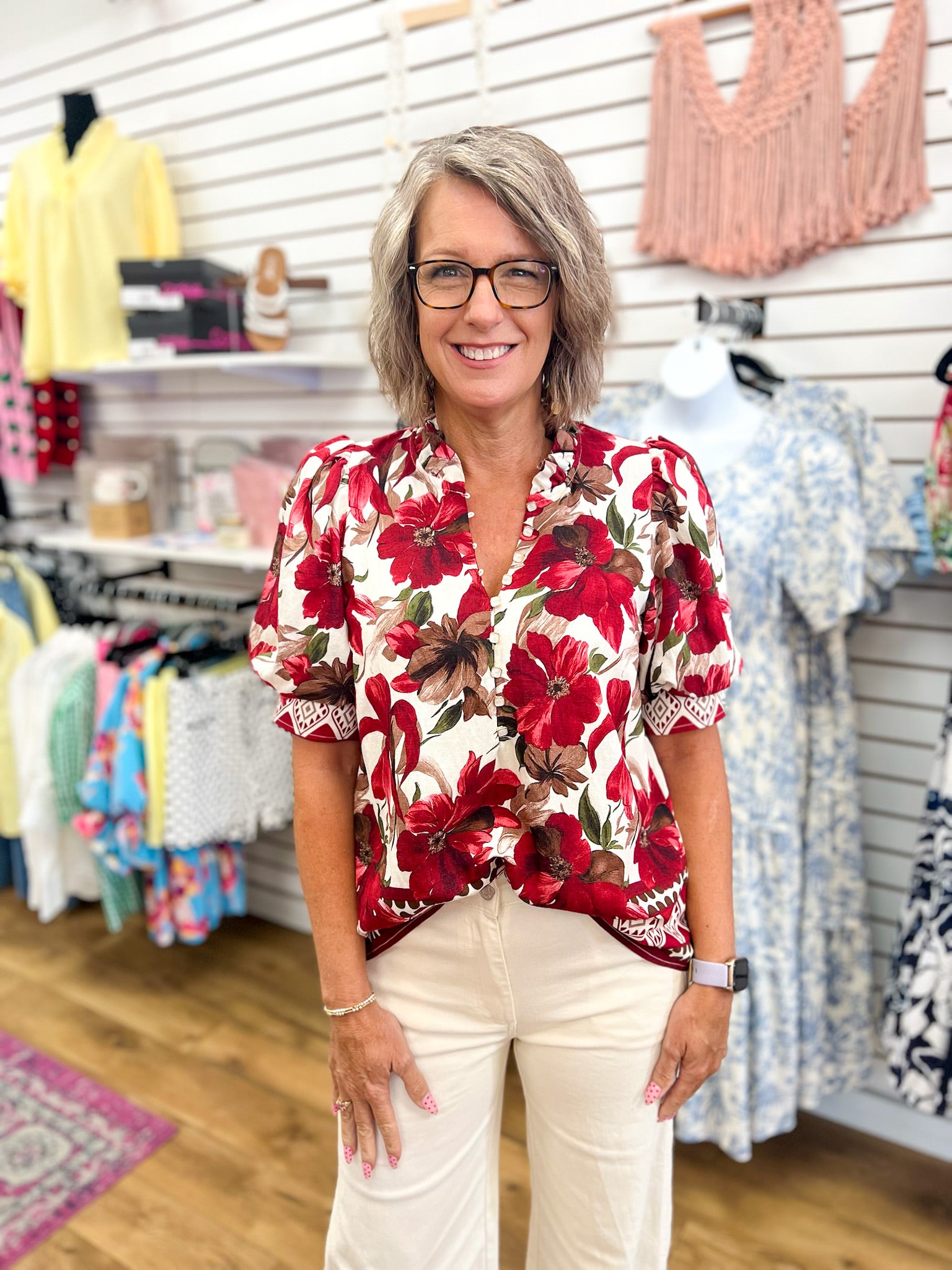 Entro burgundy floral short puff sleeve button-front top on model with cream pants