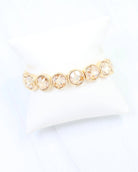 Gold stretch bracelet featuring round bezel-set champagne crystal stones in a row