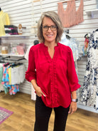 Crimson red ruffle-trim V-neck blouse with balloon sleeves and smocked cuffs