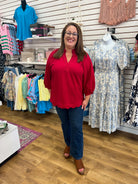 Wine red V-neck top with 3/4 balloon sleeves and scalloped hem