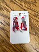 Handmade polymer clay dangle earrings in red gray and white marbled pattern on display card