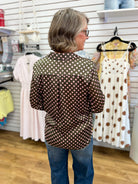 Olive satin button-up top with pink polka dots, long sleeves, worn with jeans