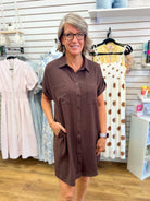 Brown button-down short sleeve shirt dress with collar, pockets, and drop shoulders