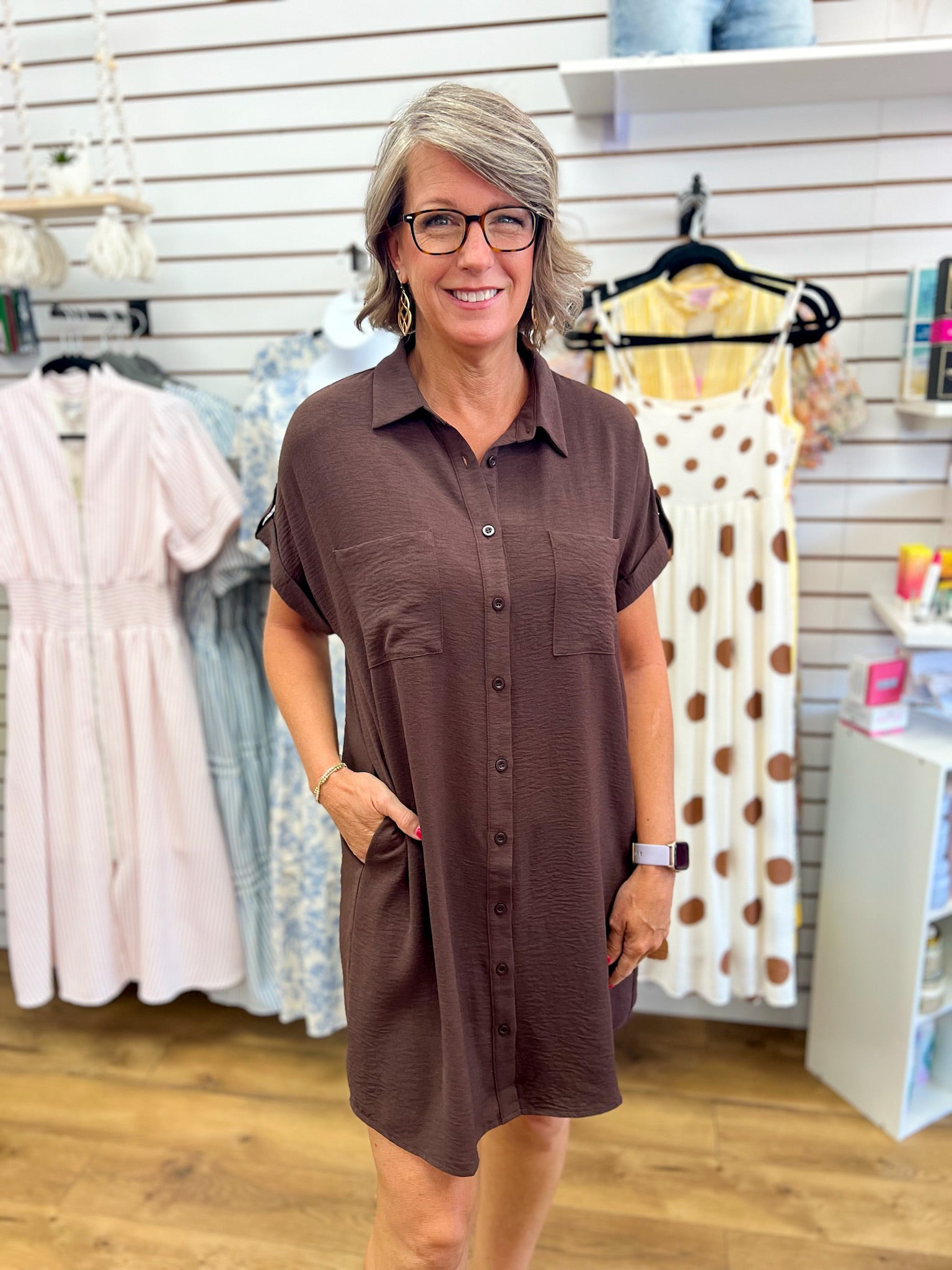 Brown button-down short sleeve shirt dress with collar, pockets, and drop shoulders