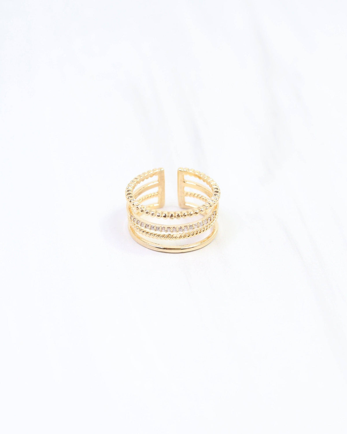Gold four-row adjustable open-back ring with crystal pavé and textured bands