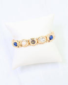 Gold stretch bracelet with blue sapphire, pearl, purple, and clear crystal stones