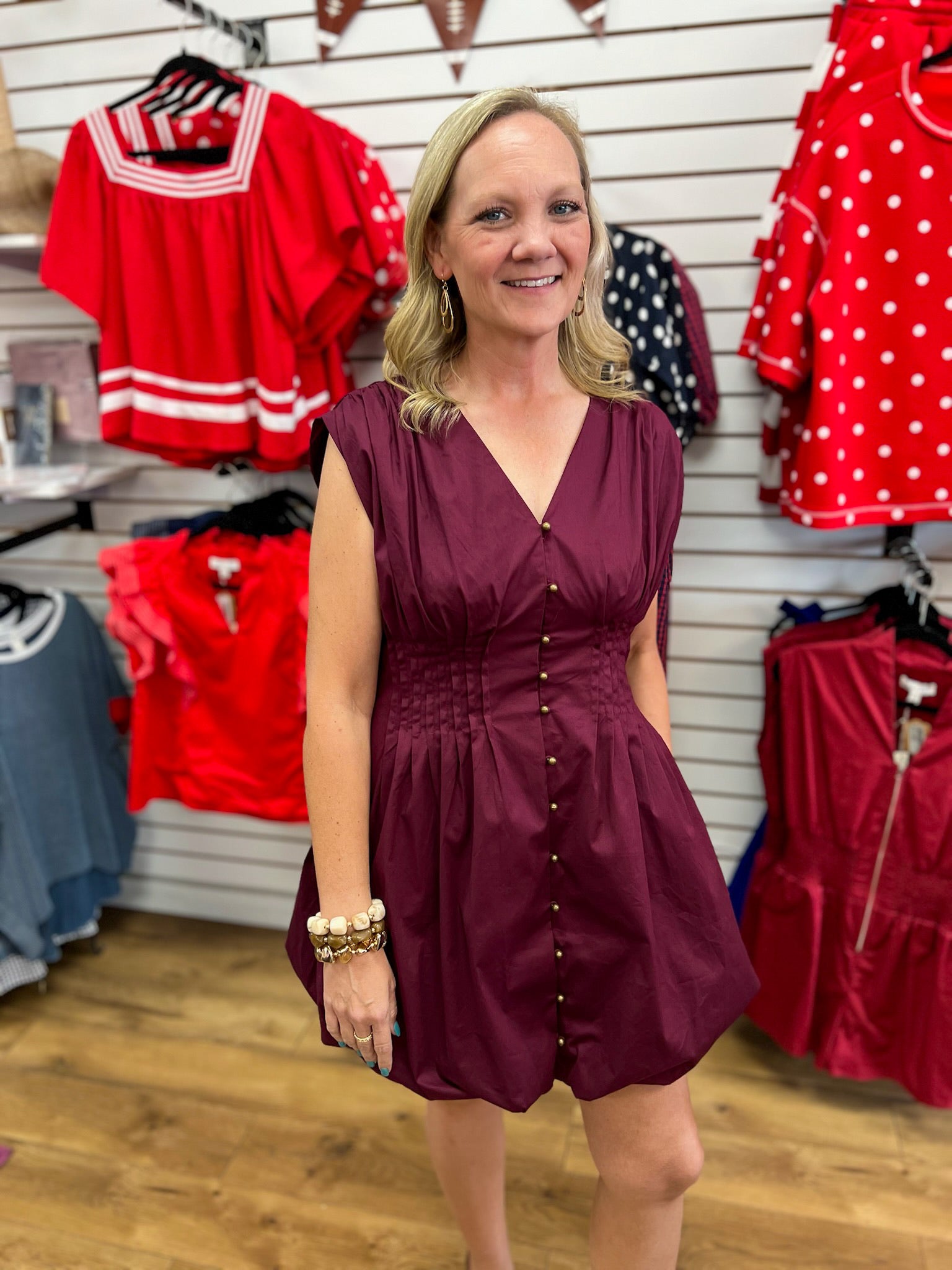 Merlot sleeveless mini dress with pintuck waist and gold button front detail