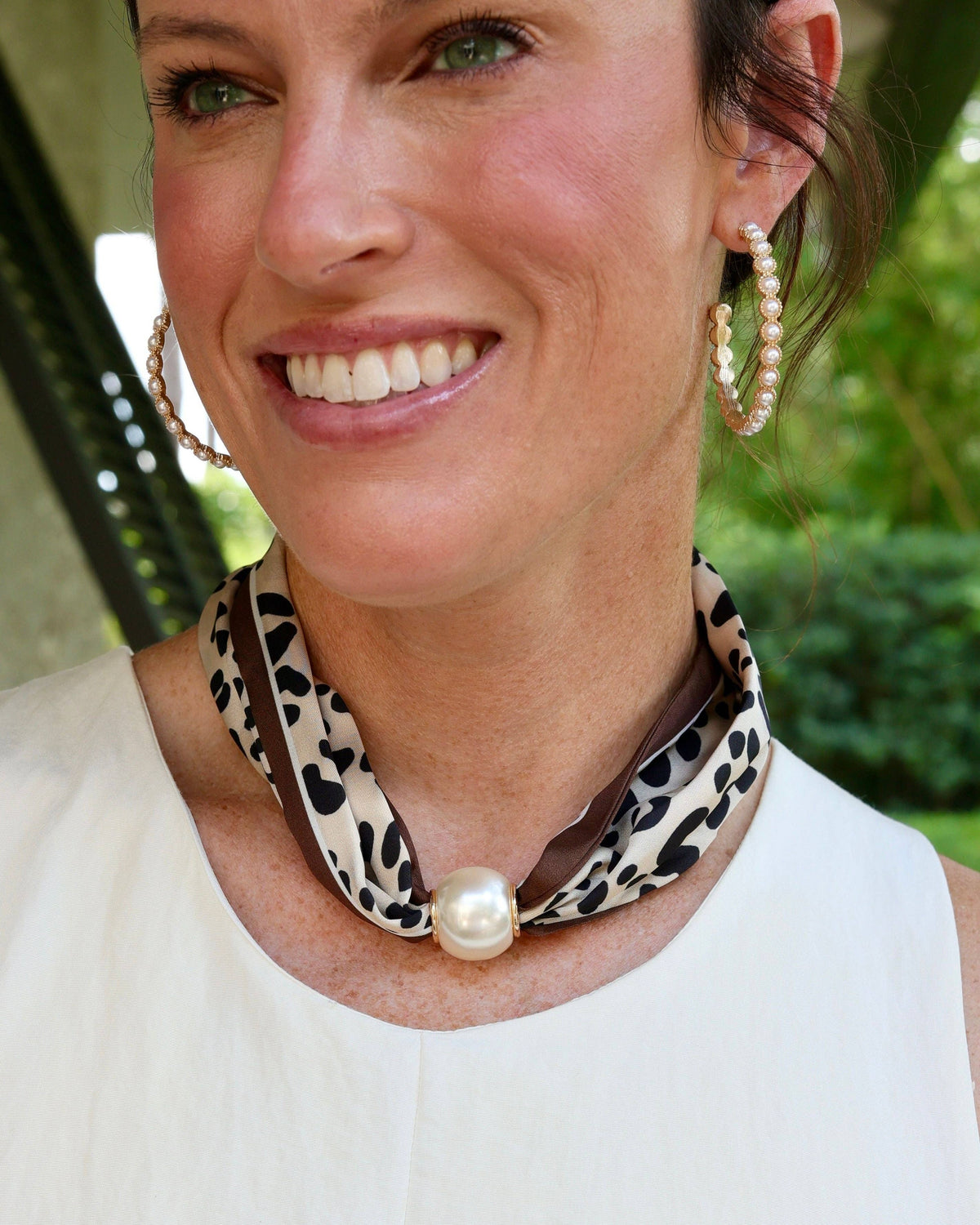 Leopard print scarf necklace with large magnetic pearl closure worn around neck