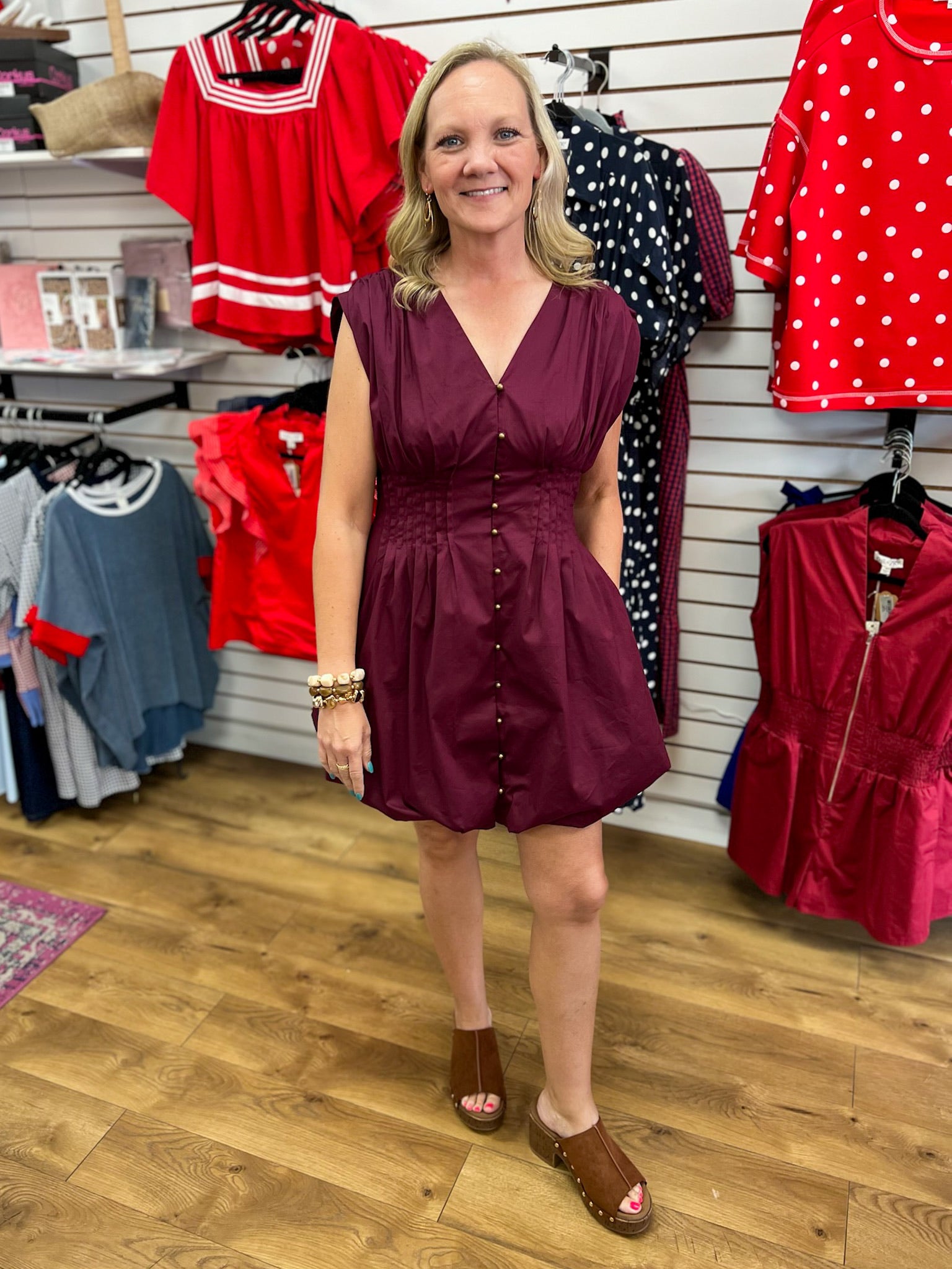 Merlot sleeveless bubble dress with pintuck waist and gold button front