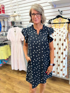 Black and white polka dot mini dress with ruffle cap sleeves and V-neck