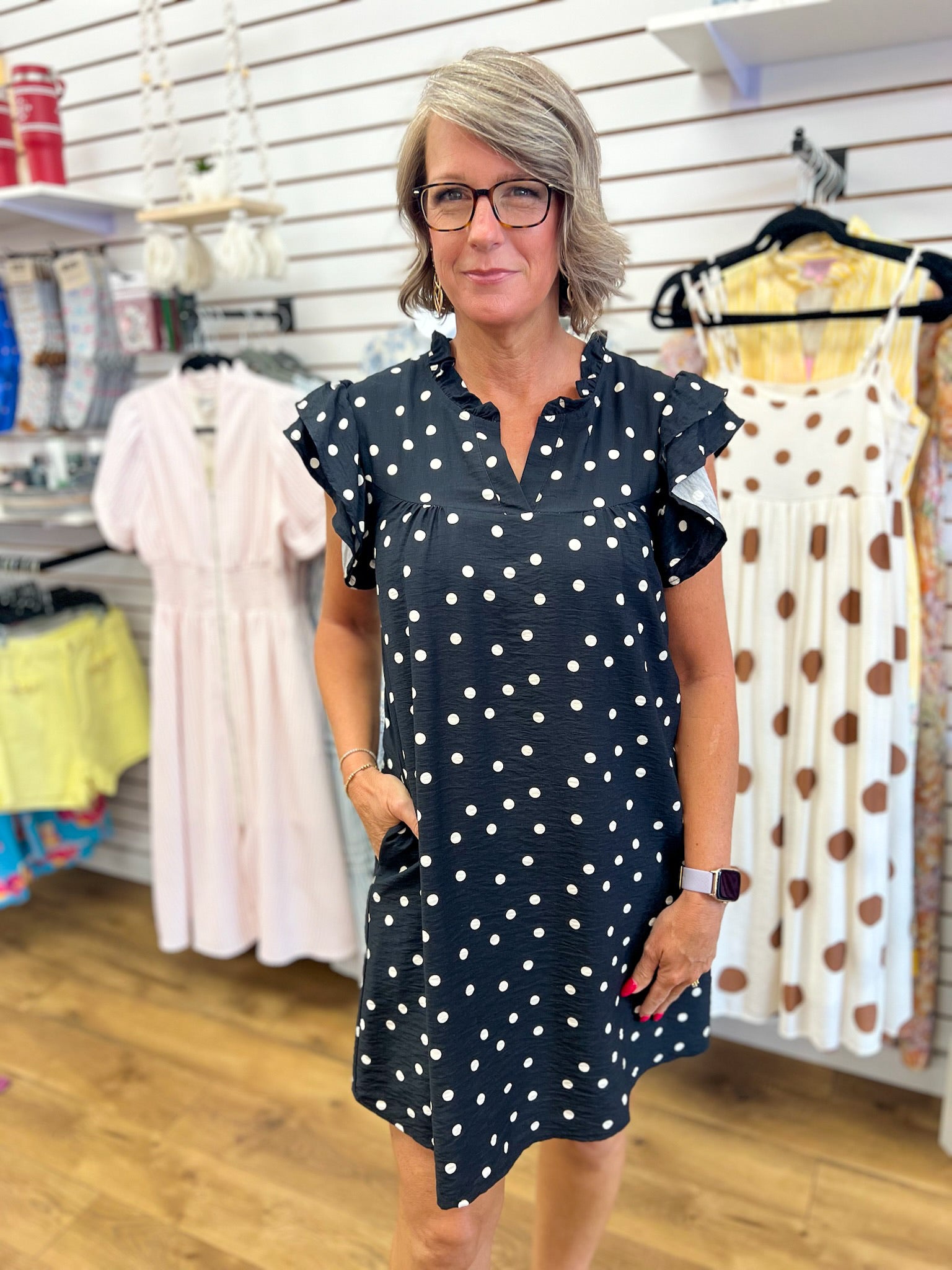 Black and white polka dot mini dress with ruffle cap sleeves and V-neck