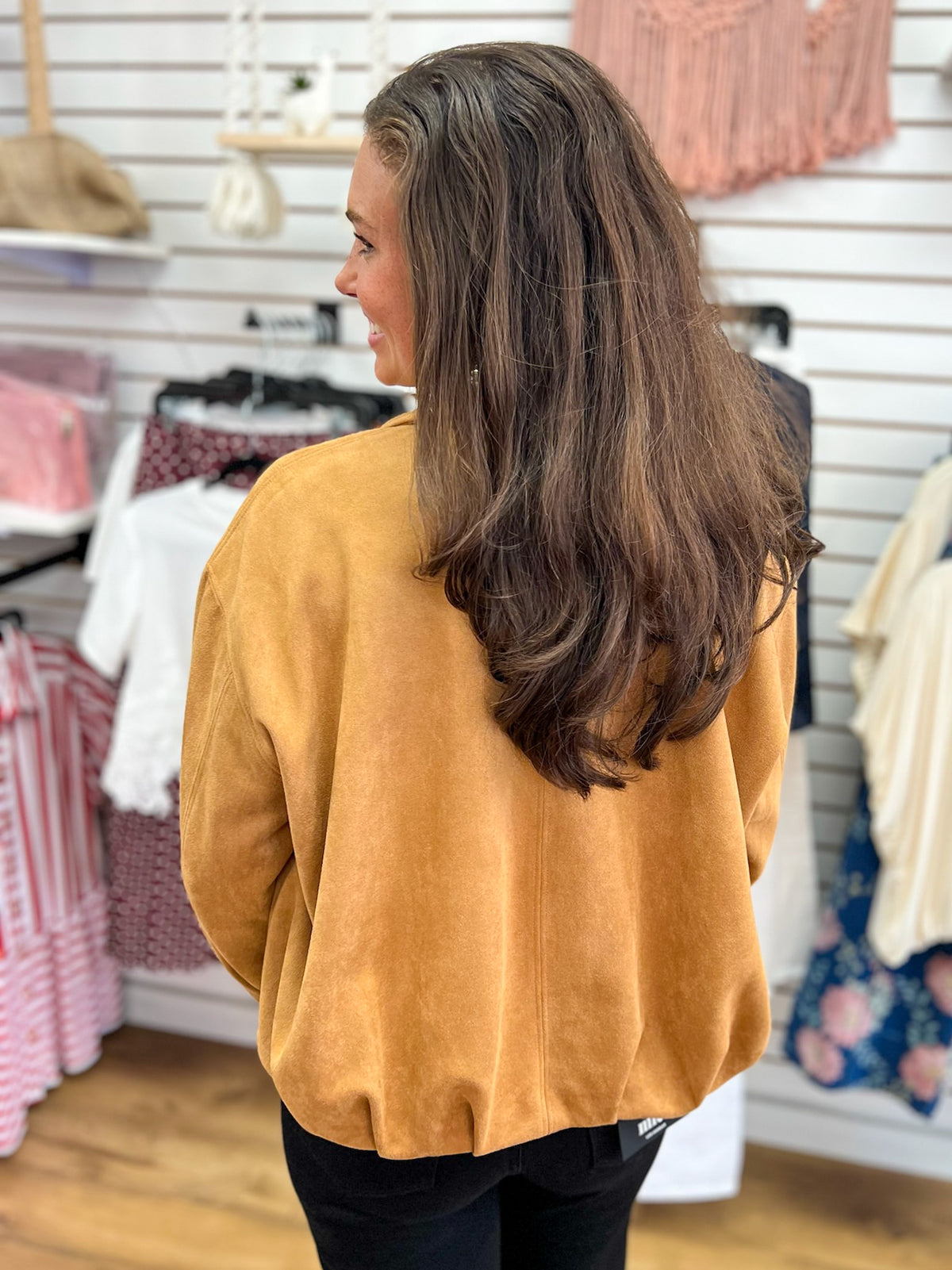 Camel faux suede bubble hem jacket shown from the back on a model