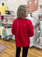 Wine red textured v-neck top with 3/4 balloon sleeves and scalloped hem