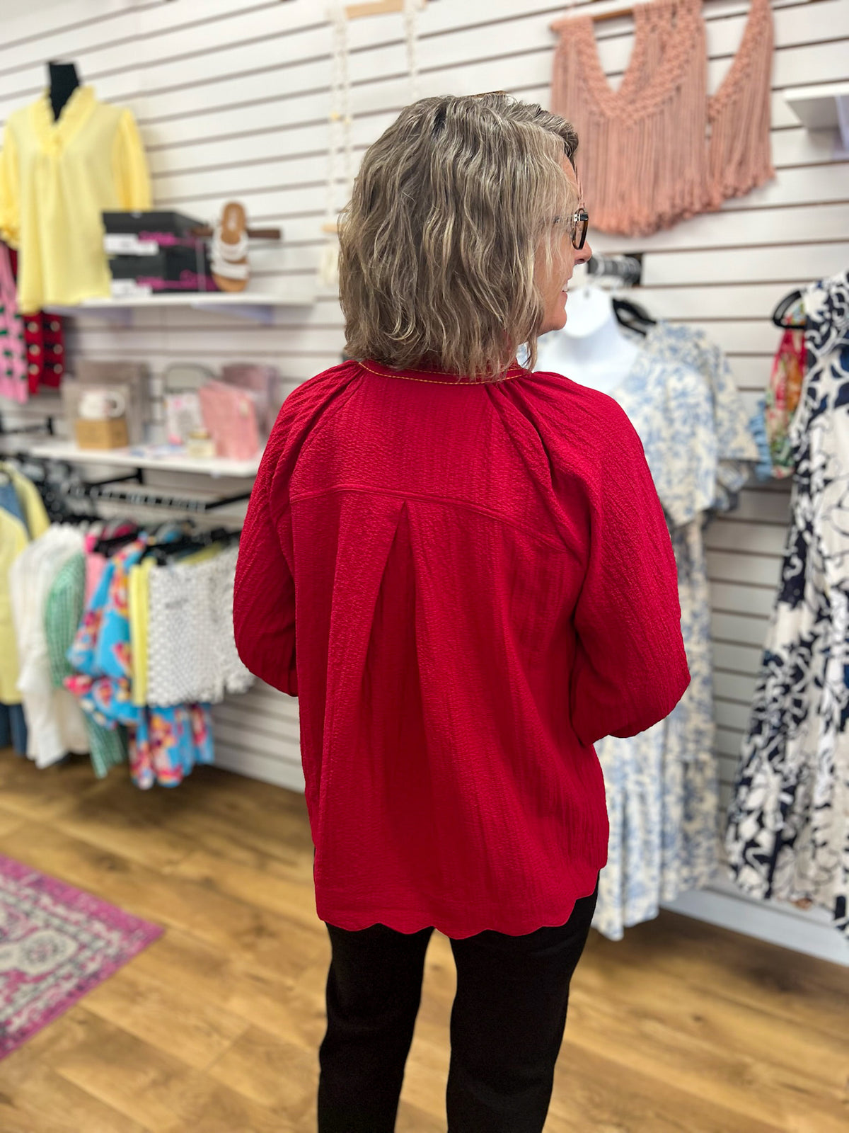 Wine red textured v-neck top with 3/4 balloon sleeves and scalloped hem