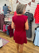 Burgundy sleeveless A-line mini dress with structured shoulders, back zipper closure