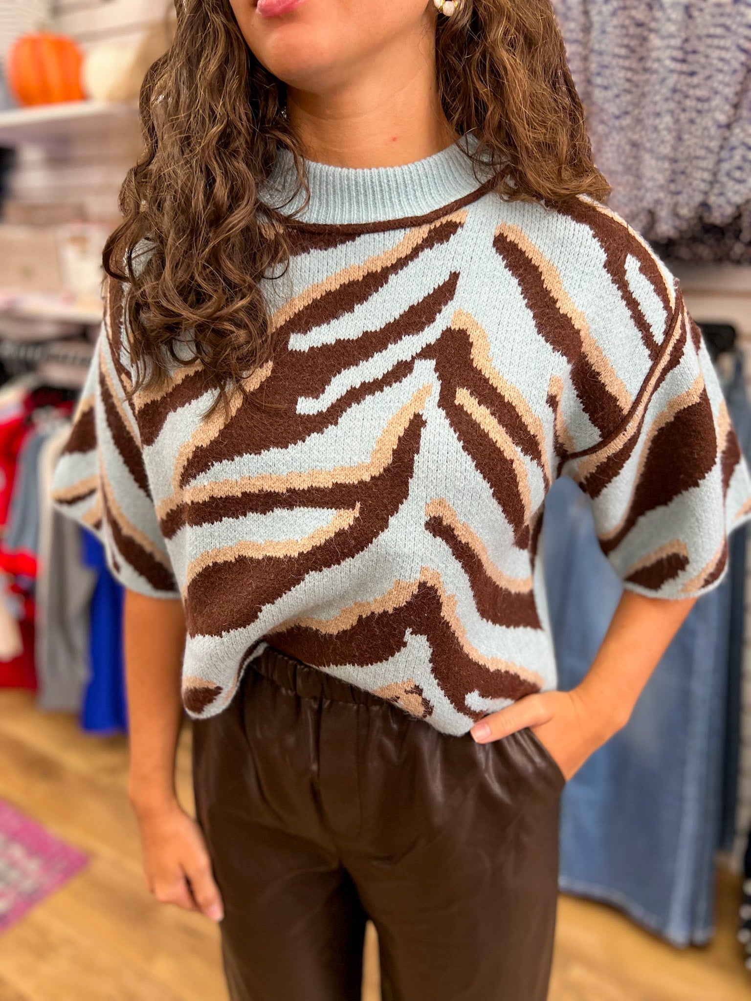 Light blue short sleeve knit sweater with brown animal print pattern and mock neck
