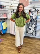 Ecru wide leg pants with scallop trim pockets and cuffed hem by Entro