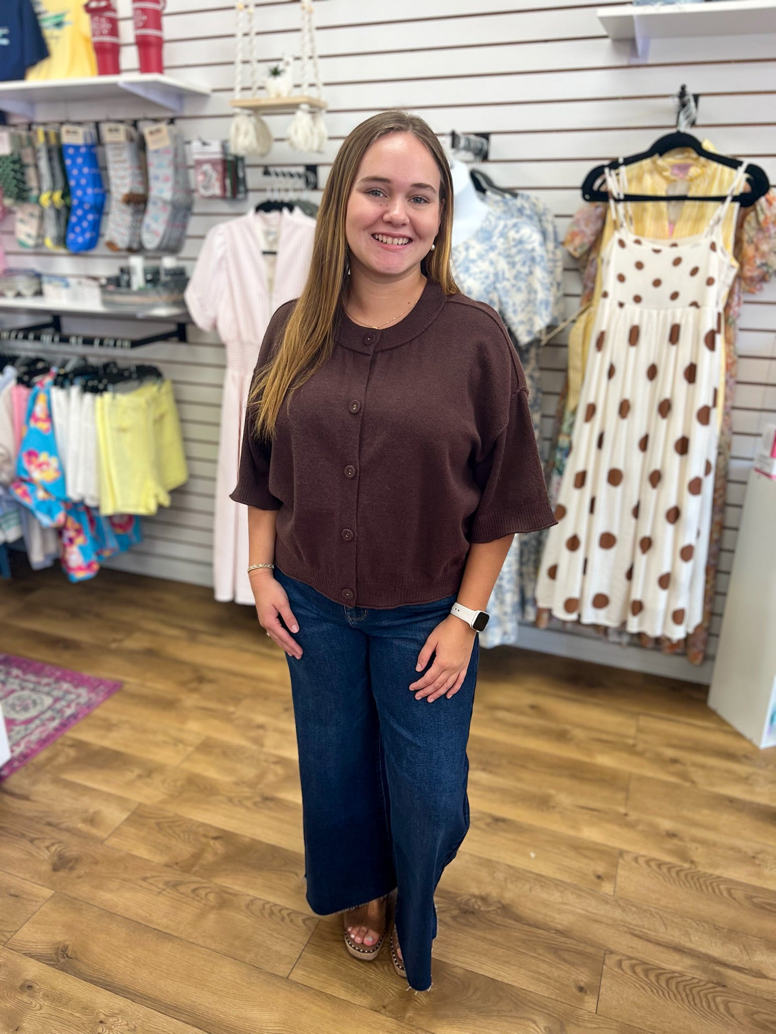 Entro brown button-up short sleeve sweater worn with wide-leg dark jeans
