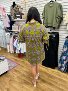 Olive green printed shirt dress with short puff sleeves and tie detail