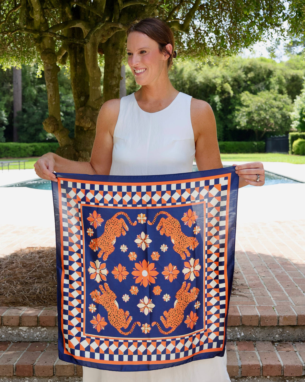Navy and orange square scarf with leopard, floral, and geometric checkered border pattern