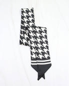 Black and white houndstooth skinny scarf with solid black pointed ends