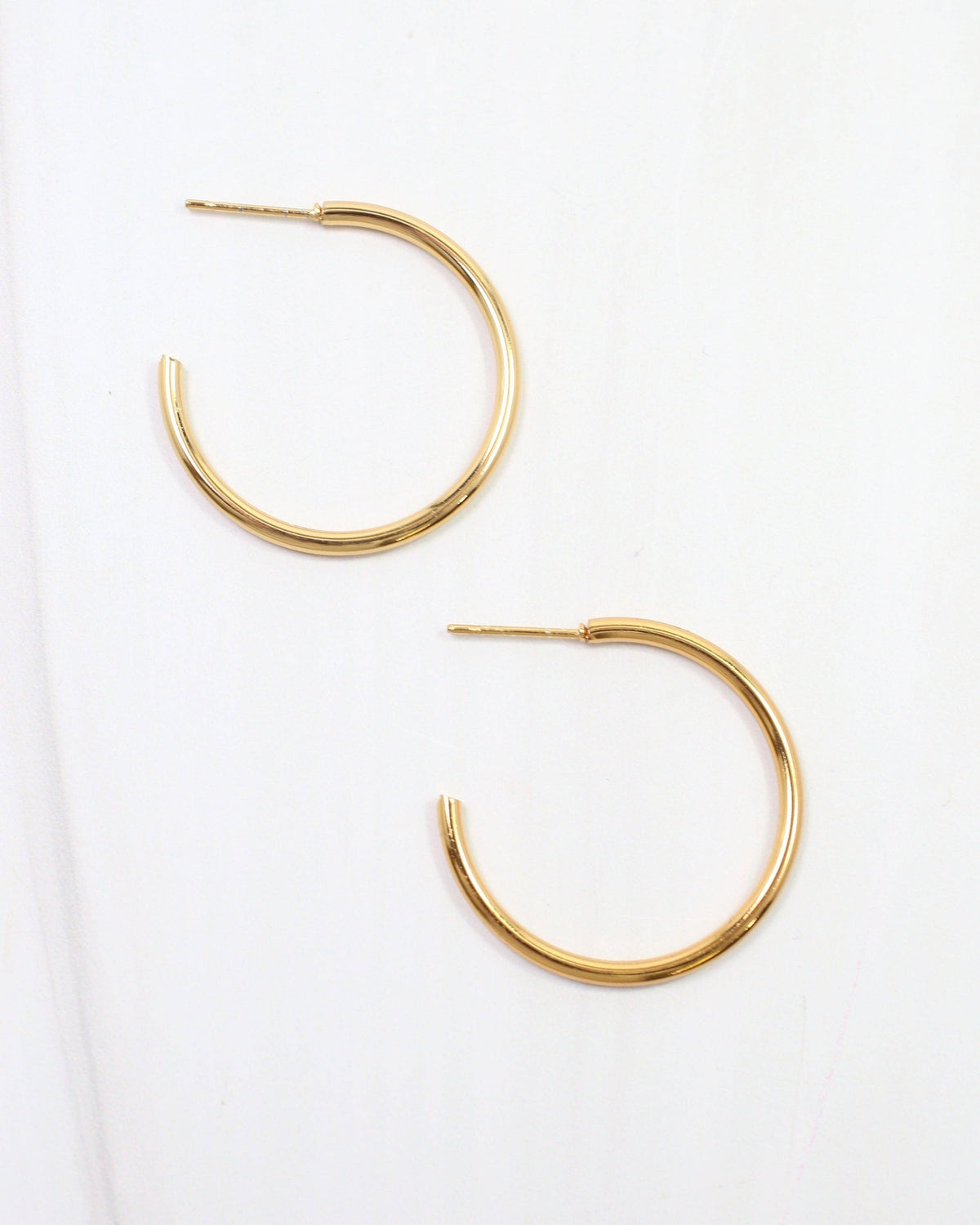Caroline Hill Mayor thin gold hoop earrings with post backs on white background