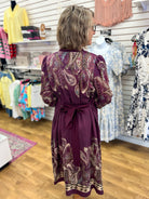 Plum paisley midi dress with tie waist and puff sleeves, back view