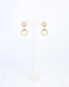 Gold drop earrings with braided rope detail and open horsebit ring pendant