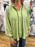 Sage green crinkle blouse with dark green contrast trim and scalloped 3/4 sleeves