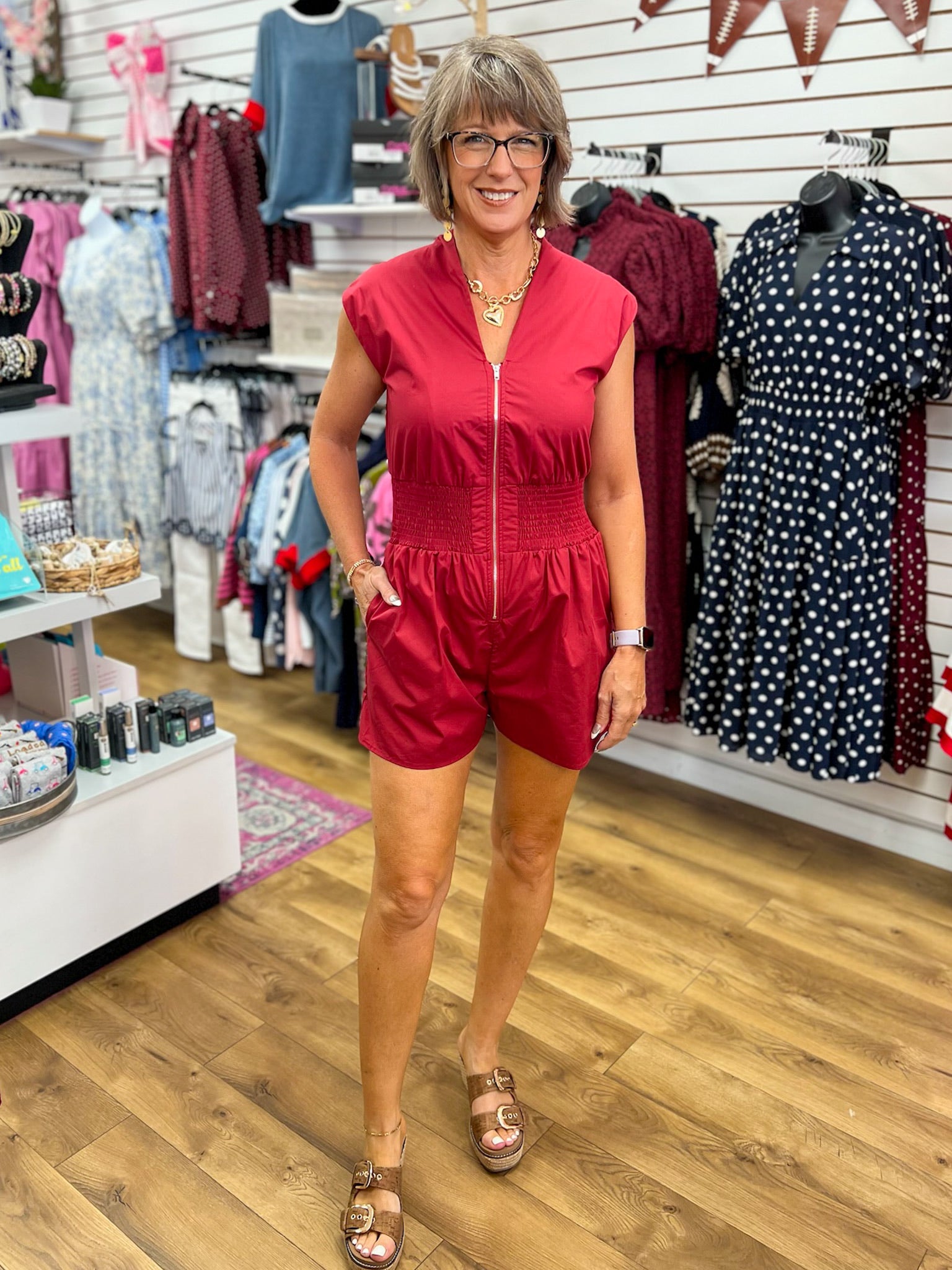 Garnet cap sleeve zip-front romper with smocked waist worn by model