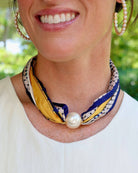 Navy yellow patterned silk scarf twisted into necklace secured with large pearl magnetic clasp