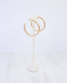 Caroline Hill Hyde Park hammered hoop earrings in worn gold on white stand