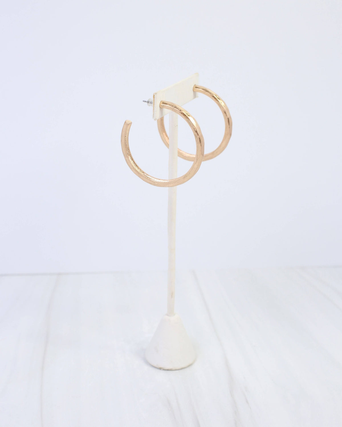 Caroline Hill Hyde Park hammered hoop earrings in worn gold on white stand