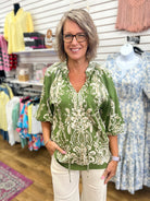 Olive green boho border print blouse with balloon sleeves and tassel v-neckline