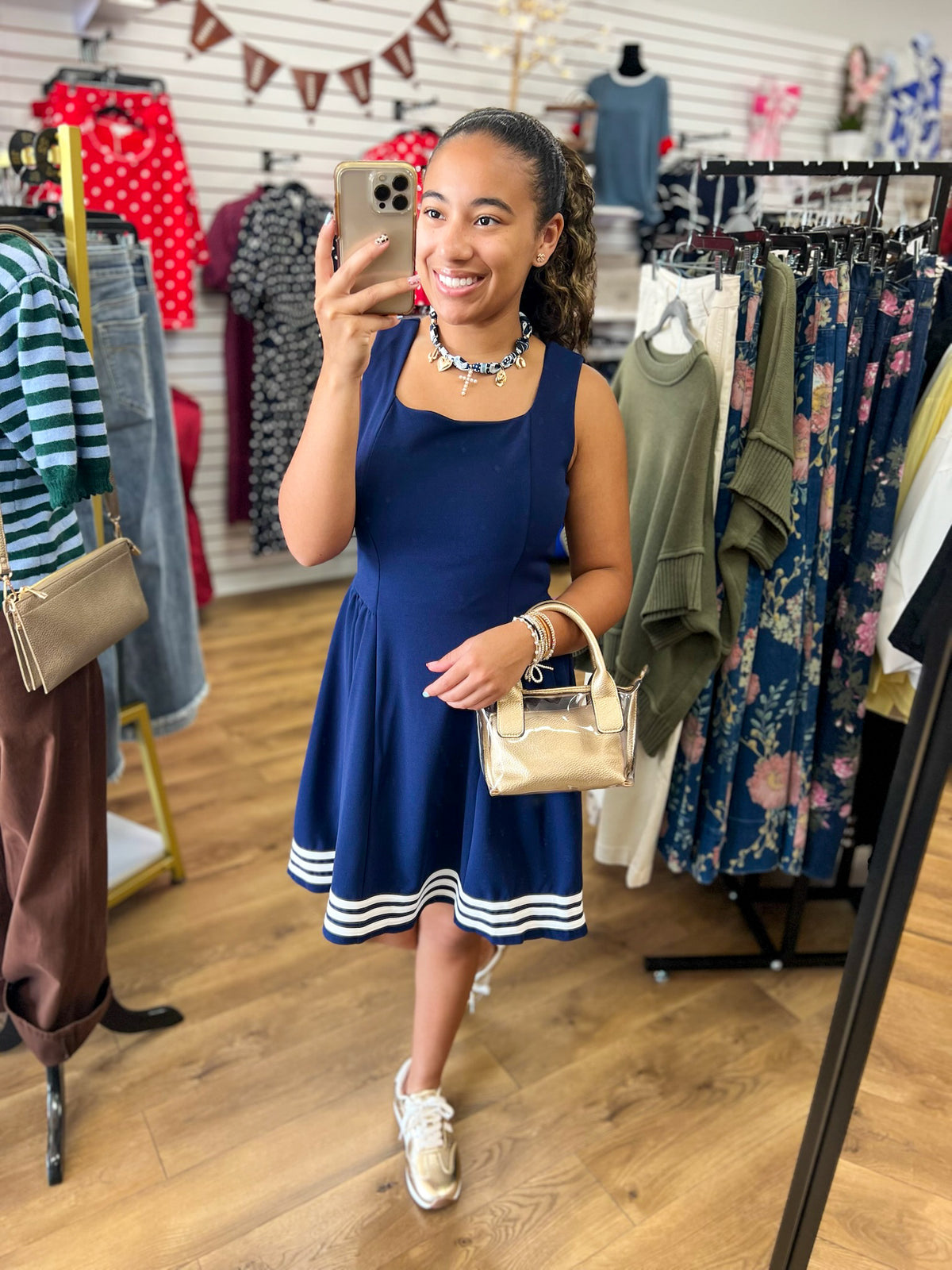 Navy sleeveless fit-and-flare dress with square neckline and white contrast stripe hem