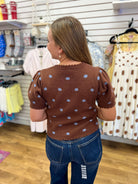 Brown short sleeve sweater with blue polka dots and scalloped trim details