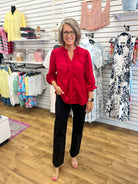 Crimson red ruffle trim V-neck blouse with long balloon sleeves on model