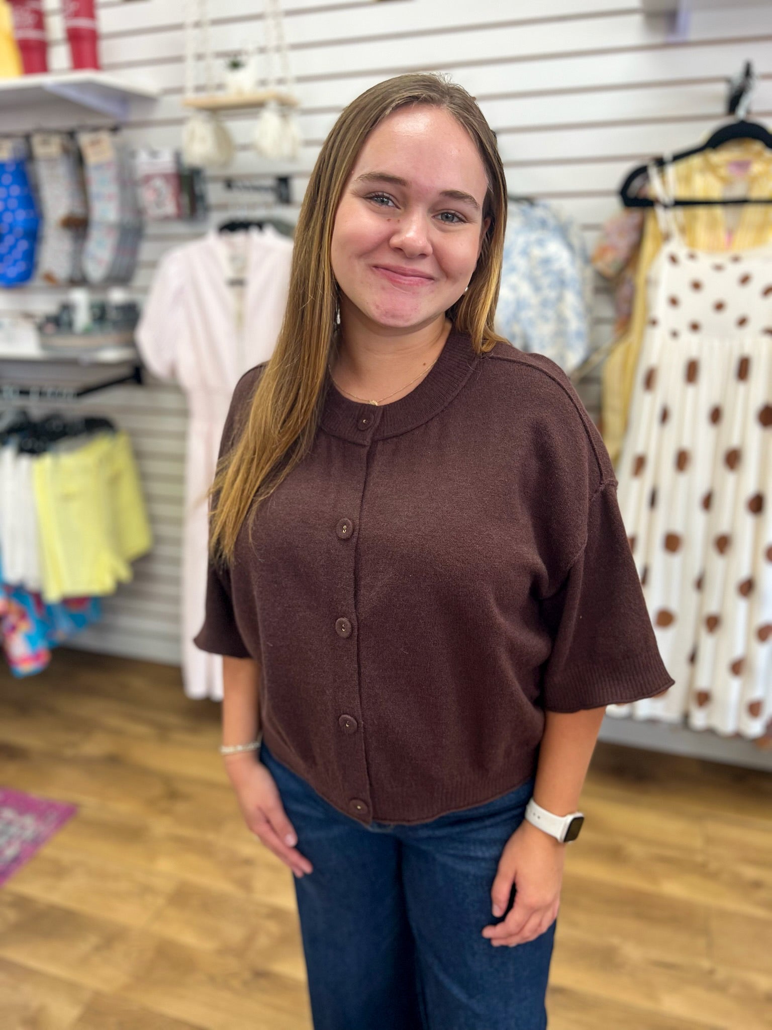Brown short sleeve button-front knit sweater with ribbed cuffs and hem on model