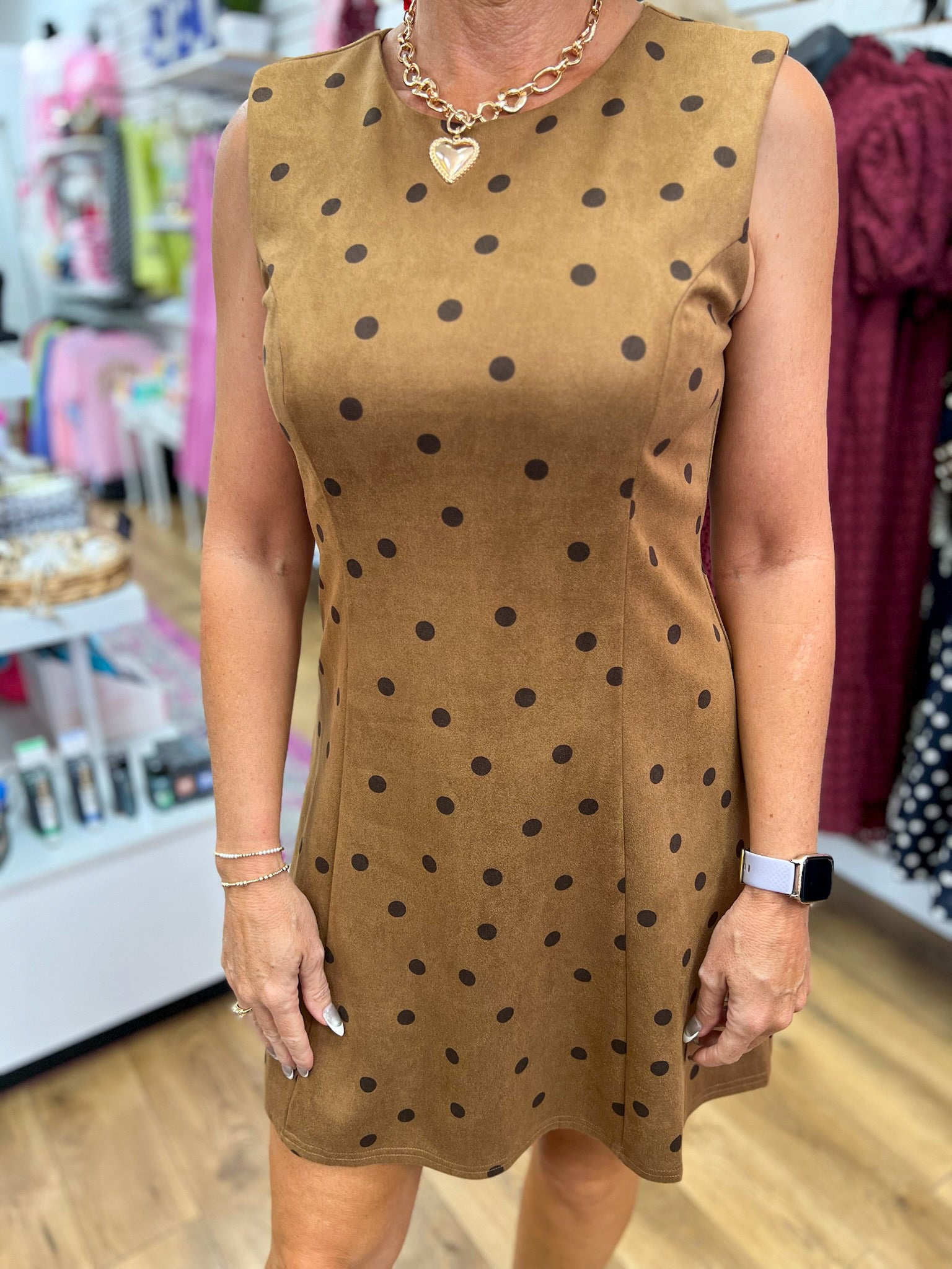 Tan sleeveless suede mini dress with dark brown polka dots and crew neckline
