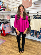 Magenta V-neck oversized top with 3/4 sleeves, worn with black pants