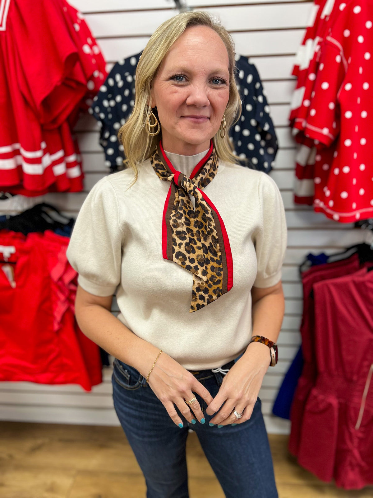 Ecru puff sleeve knit top styled with detachable leopard print red trim scarf