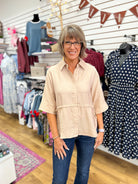 Light taupe short sleeve button-up top with drawstring waist by Entro