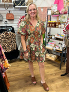 Olive green floral mini dress with rust burgundy blooms and short puff sleeves