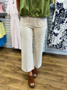 Ecru wide leg cropped pants with scallop trim front pockets and cuffed hem