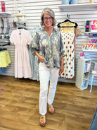 Grey floral print button-up top with 3/4 puff sleeves and collar