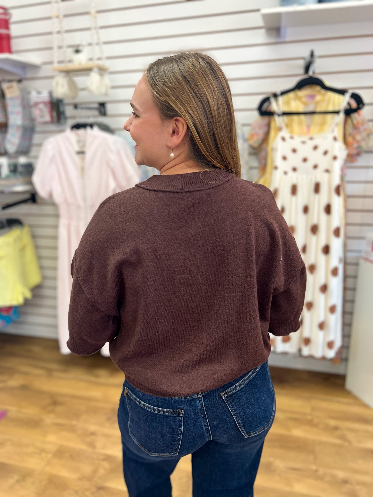 Entro brown short sleeve knit sweater, back view, paired with dark blue jeans
